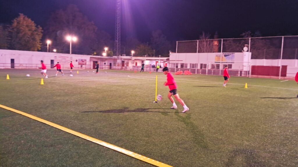 Leo playing soccer with a red top